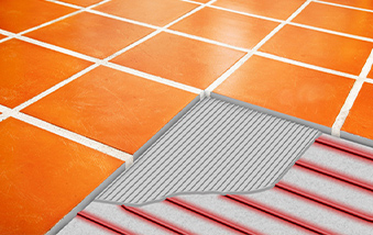 Heated tile floor with cutout showing electric heat cable.